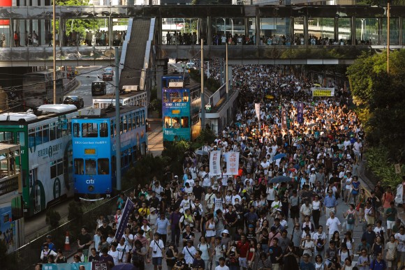 Demonstrators march in protest of the jailing of student leaders Joshua Wong, Nathan Law and Alex Chow, who were imprisoned for their participation of the 2014 pro-democracy Umbrella Movement, also known as "Occupy Central" protests, in Hong Kong China August 20, 2017. (Reuters/Tyrone Siu)