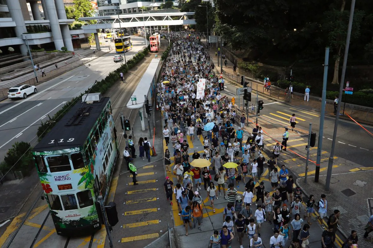 Demonstrators march in protest of the jailing of student leaders Joshua Wong, Nathan Law and Alex Chow, who were imprisoned for their participation of the 2014 pro-democracy Umbrella Movement, also known as "Occupy Central" protests, in Hong Kong China August 20, 2017. (Reuters/Tyrone Siu)
