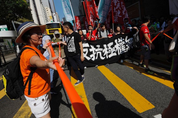 Demonstrators march in protest of the jailing of student leaders Joshua Wong, Nathan Law and Alex Chow who were imprisoned for their participation of the 2014 pro-democracy Umbrella Movement, also known as "Occupy Central" protests, in Hong Kong China August 20, 2017. Words on banner read: "Not a crime to go against totalitarianism." (Reuters/Tyrone Siu)