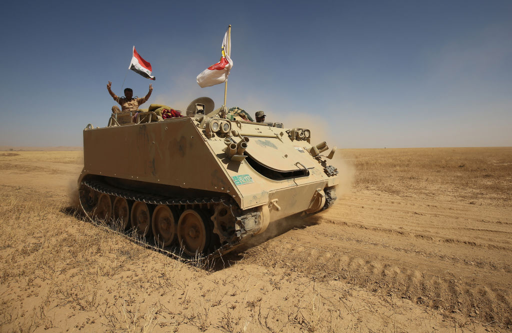 Fighters from the Hashed al-Shaabi (Popular Mobilisation) paramilitaries advance towards the city of Tal Afar, the main remaining stronghold of the Islamic State group, after the government announced the beginning of an operation to retake it from the jihadists on August 20, 2017. (AHMAD AL-RUBAYE/AFP/Getty Images)