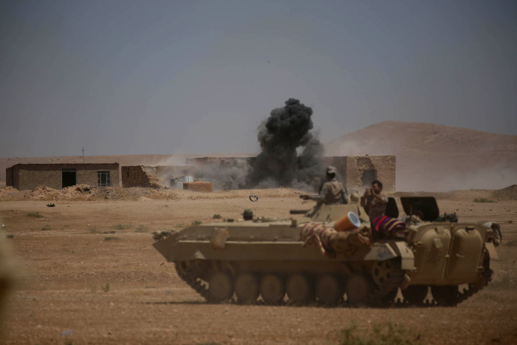 Smoke billows as Iraqi government forces supported by fighters from the Abbas Brigade, which fights under the umbrella of the Shiite popular mobilisation units, advance towards the city of Tal Afar, the main remaining stronghold of the Islamic State group, after the government announced the beginning of an operation to retake it from the jihadists on August 20, 2017. (MOHAMMED SAWAF/AFP/Getty Images)