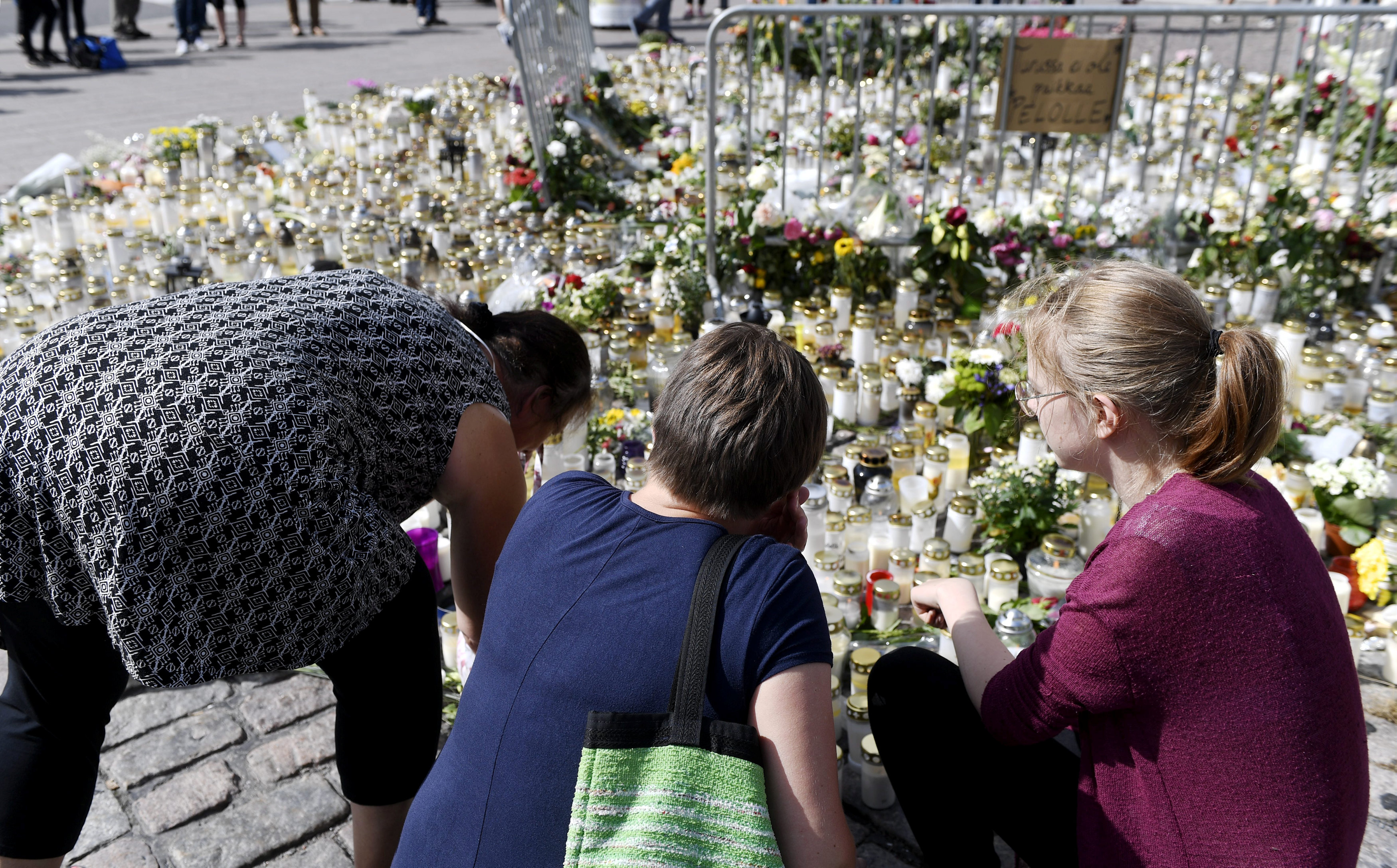 Mourners bring memorial cards, candles and flowers to the Turku Market Square, in Turku, Finland  on August 20, 2017. (Lehtikuva/Vesa Moilanen)