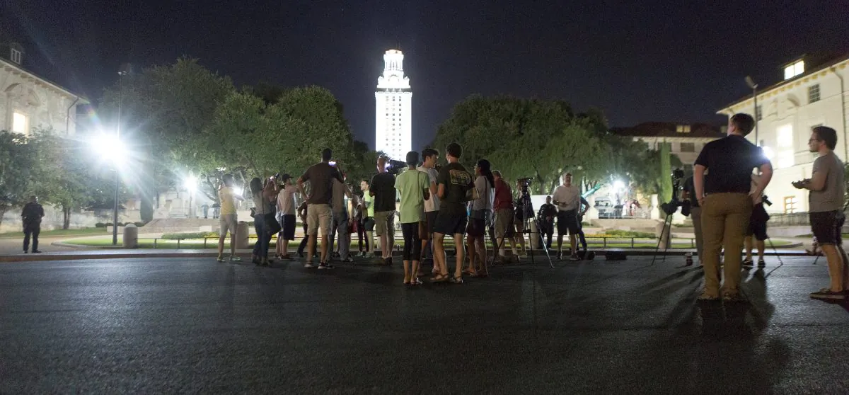 Onlookers watch as Confederate statues are removed from the University of Texas in Austin, on Aug. 21, 2017. (Stephen Spillman/Reuters)
