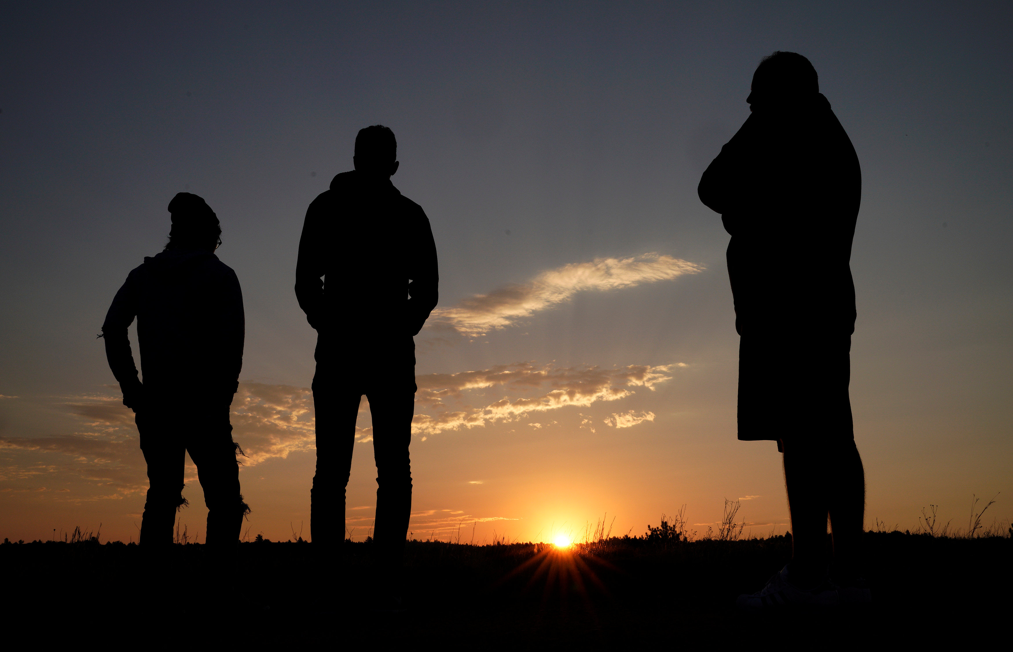 People wait for the solar eclipse as they watch the sunrise in Guernsey, Wyoming, U.S. August 21, 2017. REUTERS/Rick Wilking