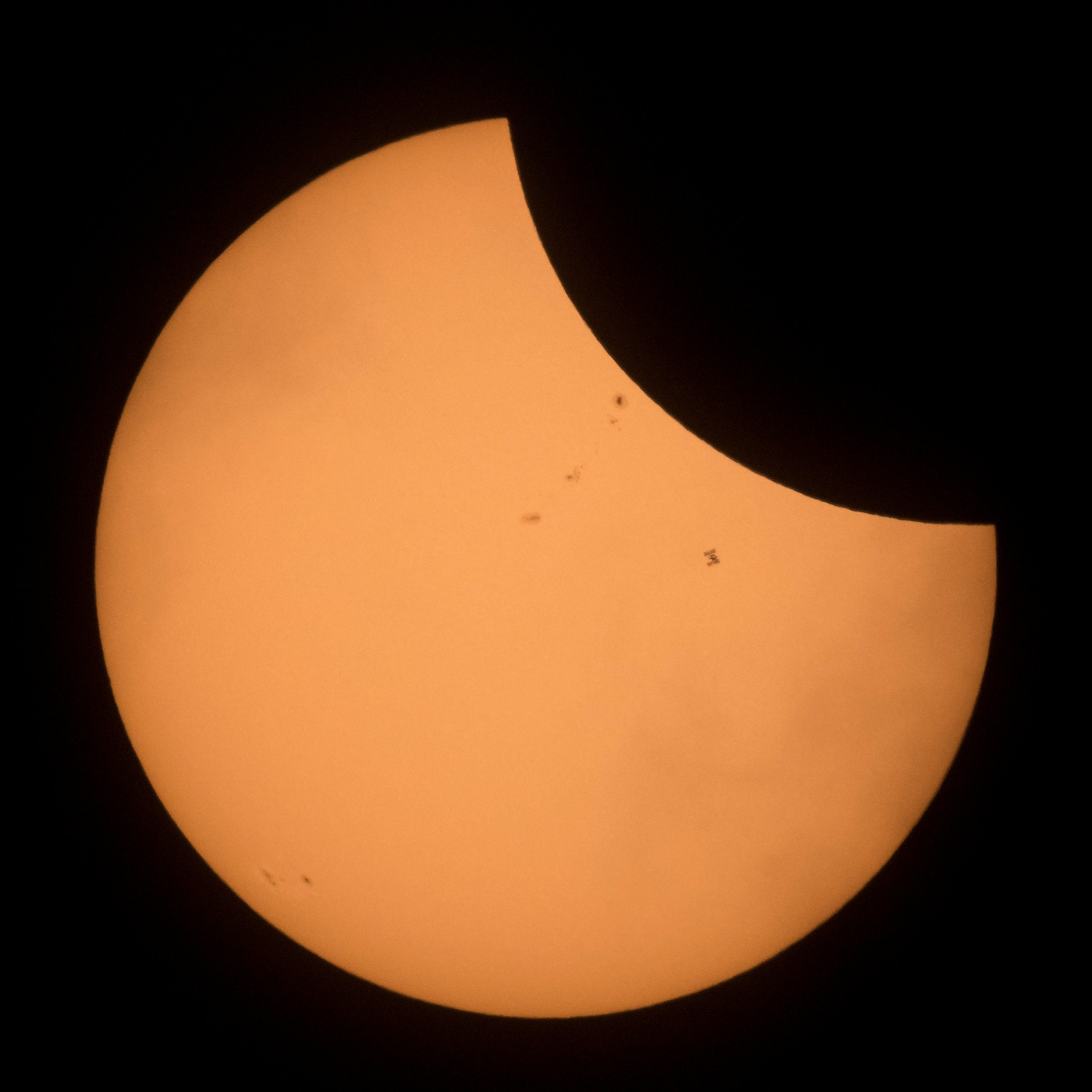The International Space Station is seen in silhouette as it transits the sun during a partial solar eclipse seen near Banner, Wyoming, U.S., August 21, 2017.   Courtesy Joel Kowsky/NASA/Handout via REUTERS