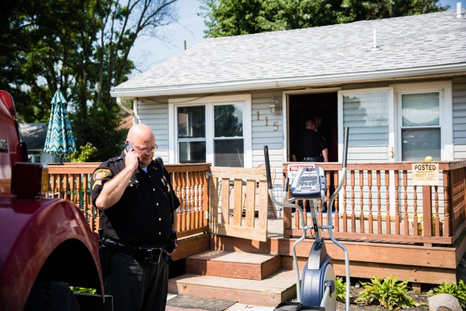 Law enforcement officials at the home of a man who was found dead from an apparent drug overdose in the Drexel neighborhood of Montgomery County, Ohio, on Aug. 3, 2017. (Benjamin Chasteen/The Epoch Times)