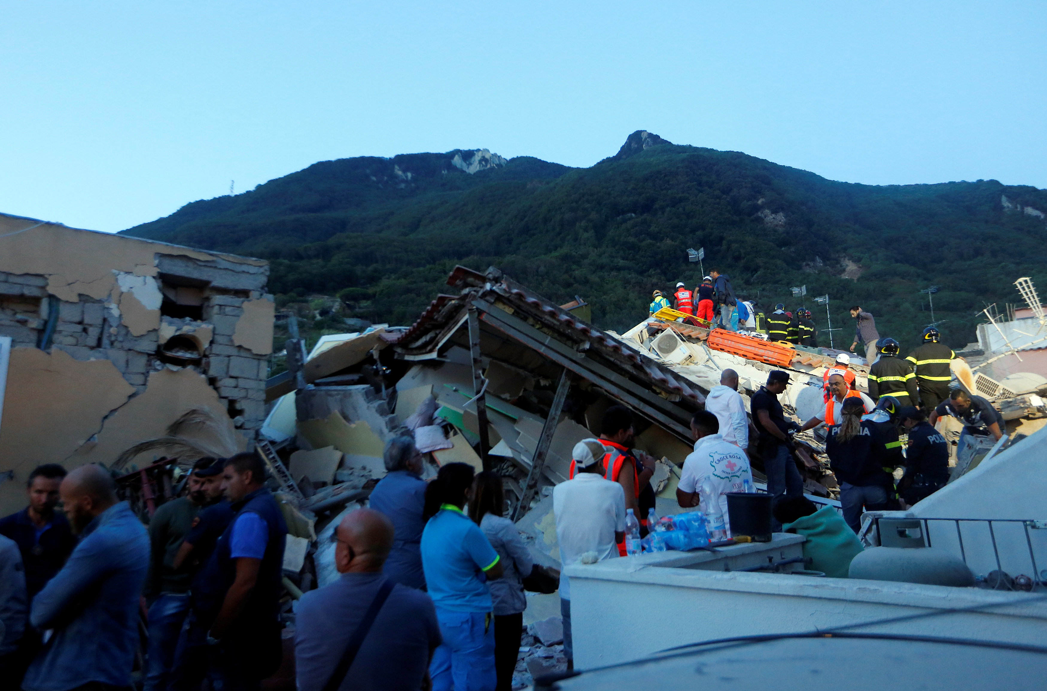 Rescue workers check a collapsed house after an earthquake hit the island of Ischia, off the coast of Naples, Italy on August 22, 2017. (REUTERS/Ciro De Luca)