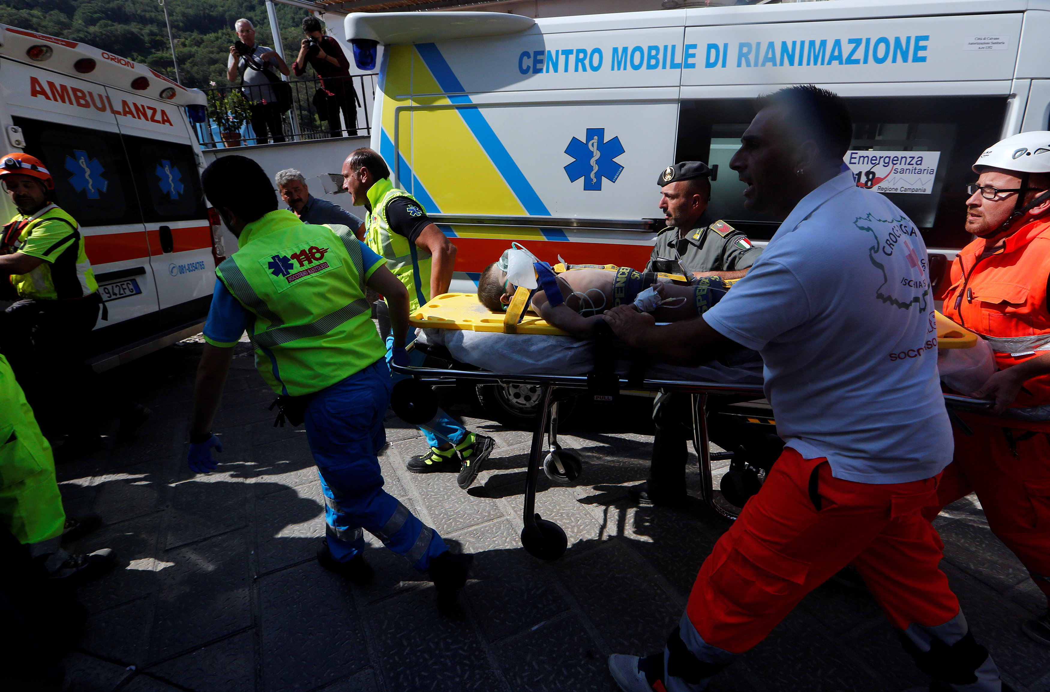 Rescue workers carry a child after an earthquake hit the island of Ischia, in Naples, Italy on August 22, 2017. (REUTERS/Ciro De Luca)