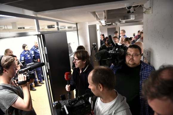 Press and and police pictured before the initial remand hearing of Abderrahman Mechkah (lying in a hospital bed, attending the court session via video), 18 year-old Moroccan man suspected of killing two people and attempting to kill eight others with terrorist intent in Turku, on Friday, August 19, is held at Southwest Finland District Court in Turku, Finland, August 22, 2017. (Lehtikuva/Martti Kainulainen via Reuters)