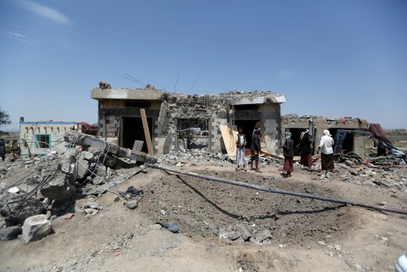 People stand at the site of Saudi-led air strikes in Arhab area, around 20 kilometres (13 miles) north of Sanaa, Yemen August 23, 2017. (Reuters/Khaled Abdullah)
