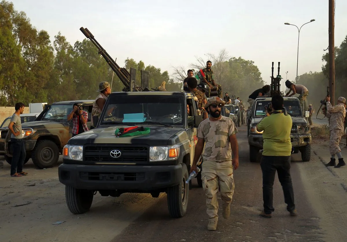 Members of the Salah Bou-Haliqa brigade, loyal to the country's east strongman Khalifa Haftar's self-styled Libyan National Army, celebrate as they arrive in the eastern city of Benghazi after seizing the central al-Jufra area from the Benghazi Defence Brigades coalition, a rival to Haftar's forces on June 5, 2017. (ABDULLAH DOMA/AFP/Getty Images)