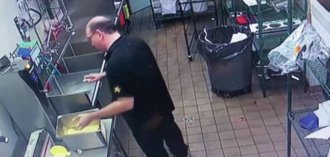 In another instance, he's seen picking of a piece of chicken before putting in the warming tray among other tenders (YouTube/screenshot)