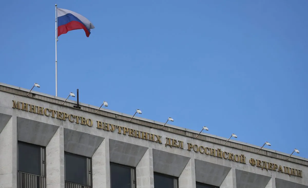 A Russian national flag flutters in the wind on top of the Russian Interior Ministry building on May 13, 2017 in Moscow. (STR/AFP/Getty Images)