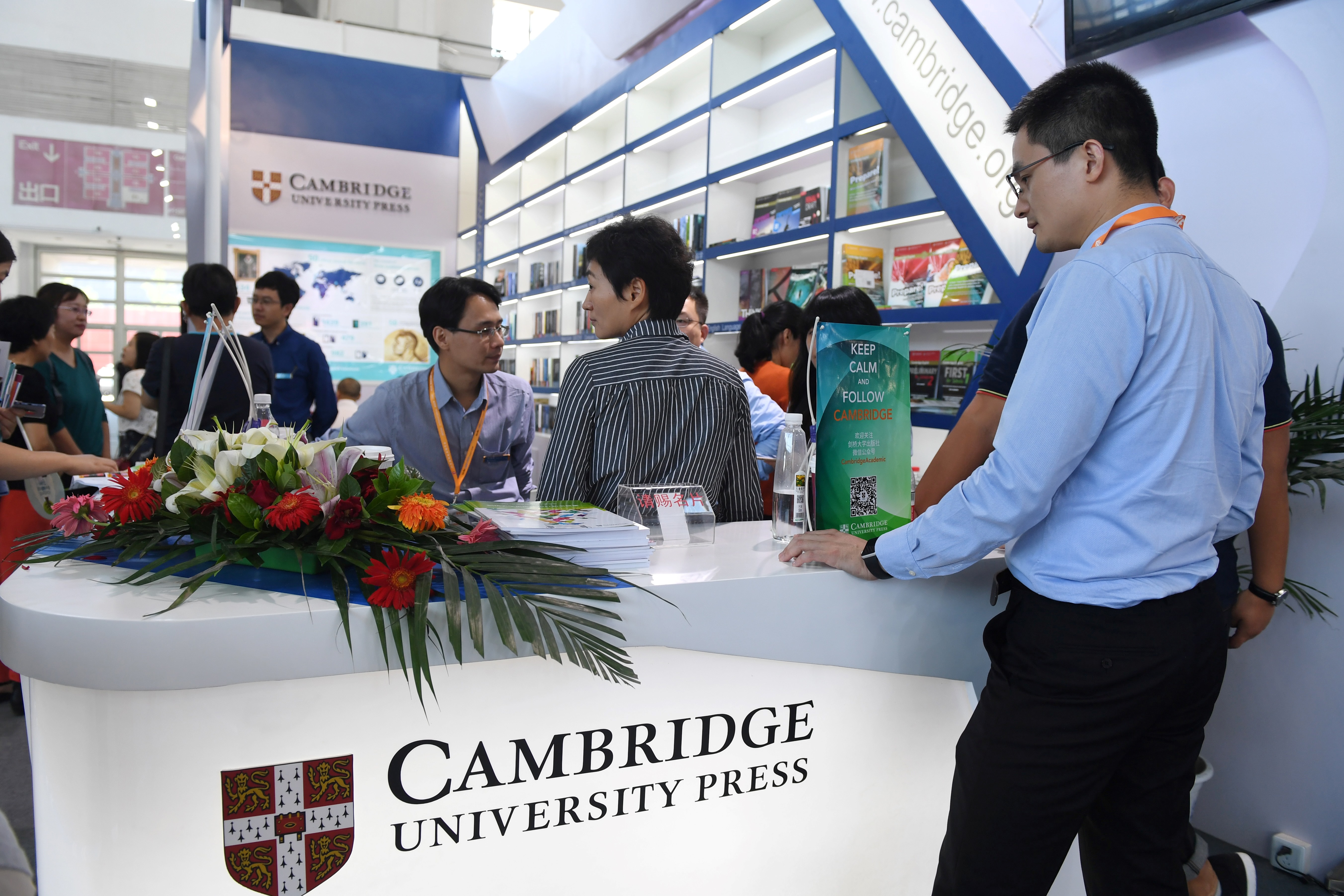 People at the Cambridge University Press at the Beijing International Book Fair in Beijing on Aug. 23, 2017. Just days after an outcry over an attempt to censor a British academic journal in China, hundreds of international publishing houses are courting importers at a major book fair in Beijing. (GREG BAKER/AFP/Getty Images)