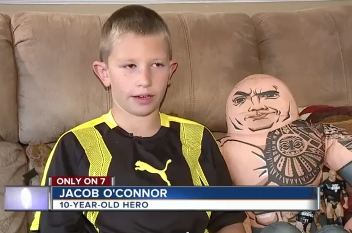 Jacob O'Connor sits with The Rock's WWE Wrestling Buddy during an interview with WKYZ on Aug 23. (Screenshot via WKYZ)
