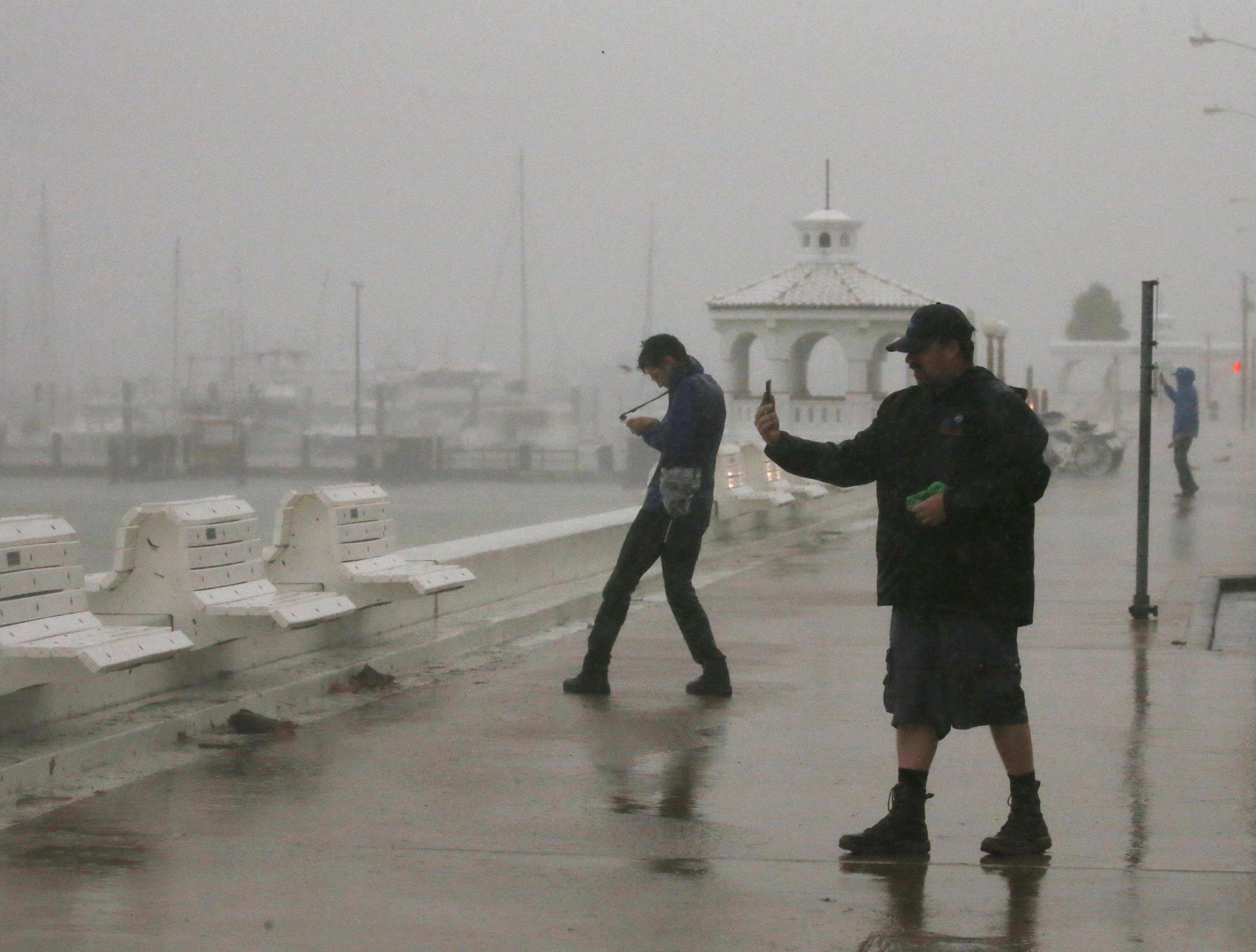 A storm chaser films himself on a camera phone as Hurricane Harvey approaches, on the boardwalk in Corpus Christi, Texas. (REUTERS/Adrees Latif)