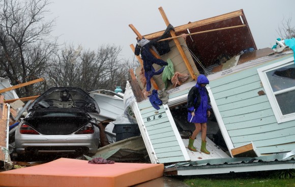 A woman leaves the doorway of a destroyed house after Hurricane Harvey struck Fulton, Texas, August 26, 2017. (REUTERS/Rick Wilking)
