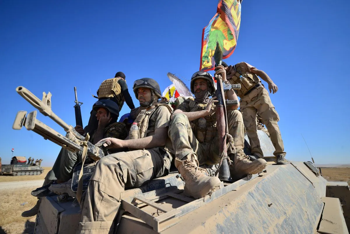 Shi'ite Popular Mobilization Forces (PMF) with Iraqi army gather on the outskirts of Tal Afar. (Reuters/Stringer)
