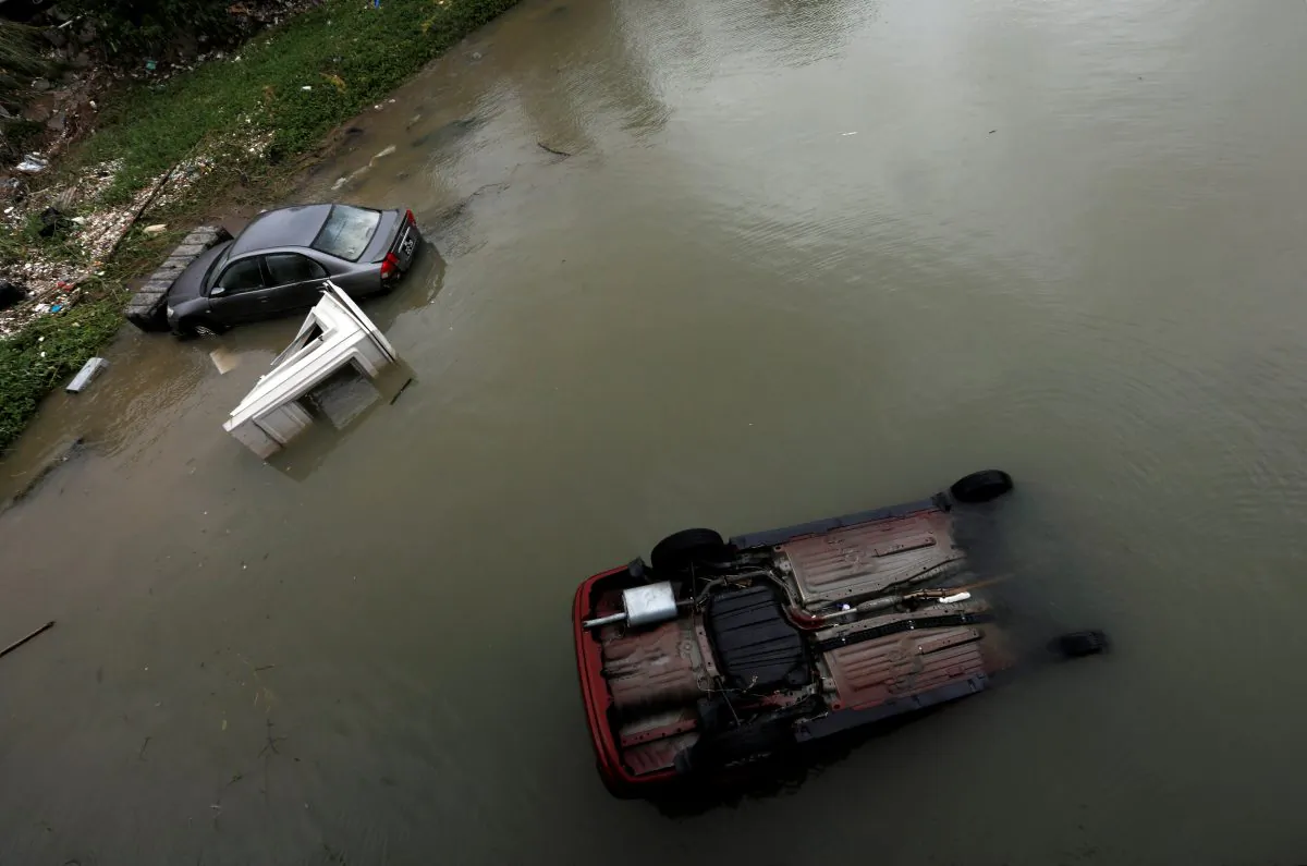 Vehicles are seen broken down and bring blown into sea by Typhoon Hato as Tropical storm Pakhar hits Macau, China on Aug. 27, 2017. (REUTERS/Tyrone Siu)