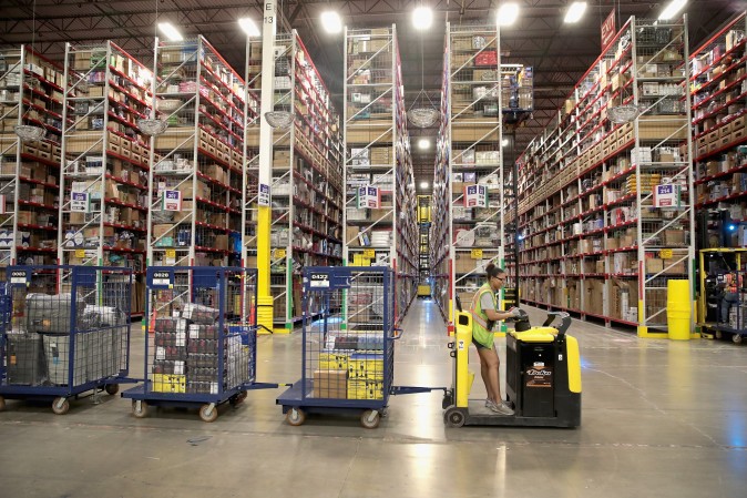 A Worker packs and ships customer orders at the 750,000-square-foot Amazon fulfillment center in Romeoville, Ill., on Aug. 1. (Scott Olson/Getty Images)