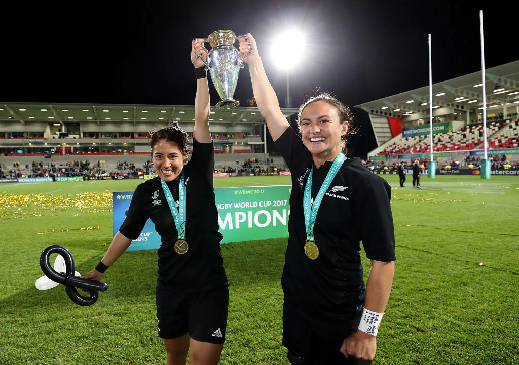 Lesley Ketu (L) and Kristina Sue (R) of New Zealand celebrate with the trophy following the Women's Rugby World Cup 2017 Final between England and New Zealand on August 26, 2017 in Belfast, United Kingdom. (David Rogers/Getty Images)