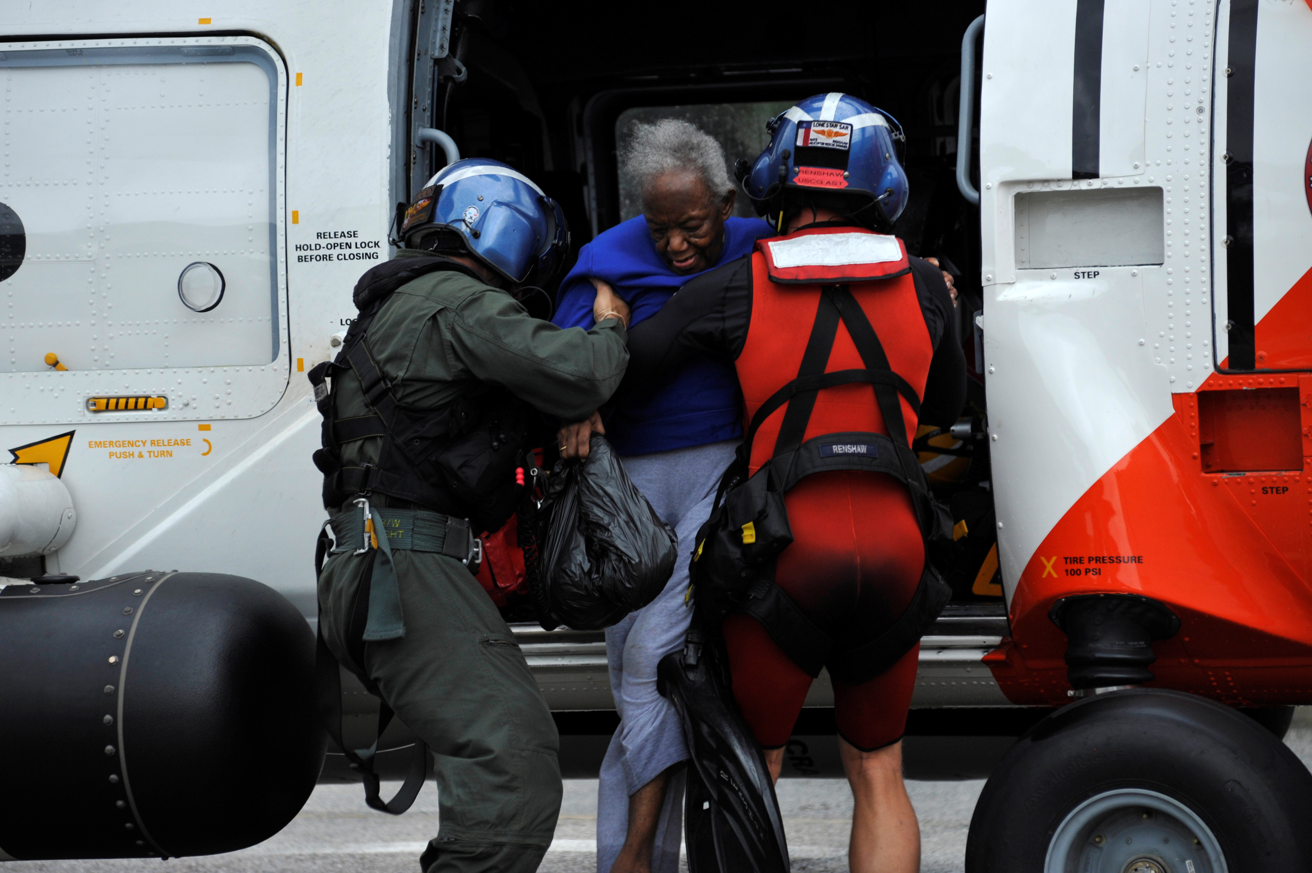 Irene Fitzgerald exits a U.S. Coast Guard helicopter that rescued her from her home after Hurricane Harvey inundated the Texas Gulf coast with rain causing widespread flooding, in Houston, Texas on Aug. 27, 2017. (REUTERS/Nick Oxford)