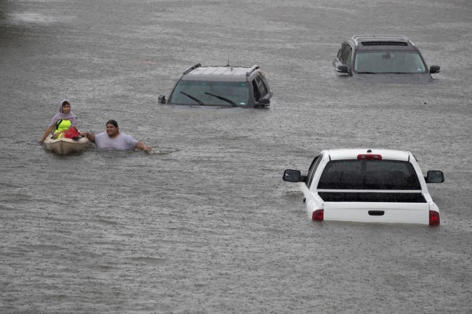 Jesus Rodriguez rescues Gloria Garcia in Pearland, in the outskirts of Houston. (REUTERS/Adrees Latif)