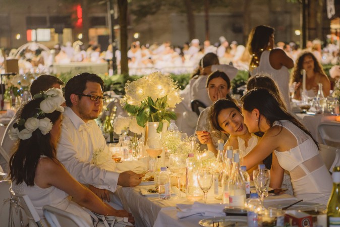 Guests attend the annual Diner en Blanc at Lincoln Center in New York on Aug. 22, 2017. Diner en Blanc began in France nearly 30 years ago and is held around the world. (Light Feather for Diner en Blanc) 