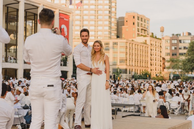 Guests attend the annual Diner en Blanc at Lincoln Center in New York on Aug. 22, 2017. Diner en Blanc began in France nearly 30 years ago and is held around the world. (Light Feather for Diner en Blanc) 