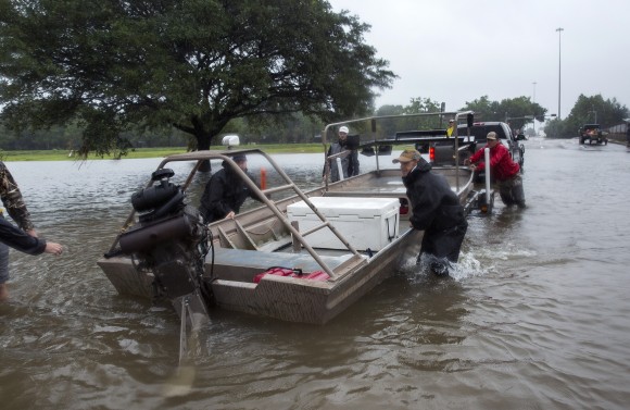 Volunteer search and rescuers from Passion Pursuit film production company launch their motor boat near Bray Bayou and Loop 610 to rescue flood victims in the Meyerland neighborhood after Hurricane Harvey inundated the area Aug. 28, 2017 in Houston, Texas. (Erich Schlegel/Getty Images)