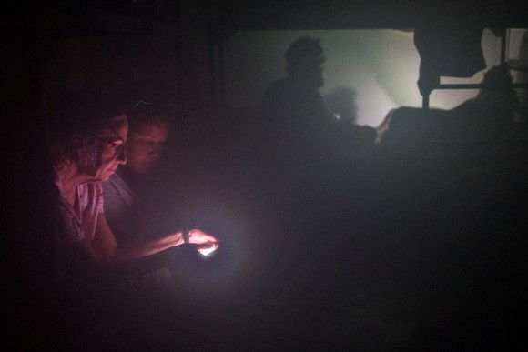 Women are illuminated by the light of a smart phone as they seek refuge in the Good Samaritan Rescue Mission during Hurricane Harvey in Corpus Christi, Texas, U.S., August 25, 2017. (Reuters/Adrees Latif)