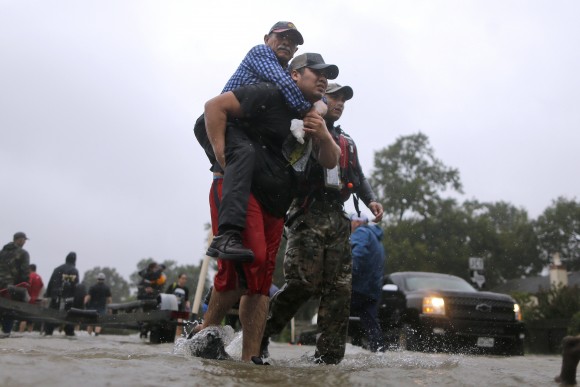 An elderly man is carried after being rescued from the flood waters of tropical storm Harvey in east Houston, Texas, U.S., August 28, 2017. (Reuters/Jonathan Bachman)