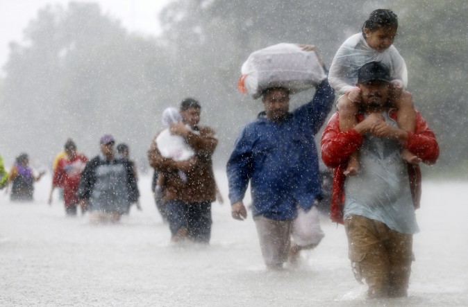 Residents wade through flood waters from Tropical Storm Harvey in Beaumont Place, Houston, Texas, U.S., on August 28, 2017. (REUTERS/Jonathan Bachman)