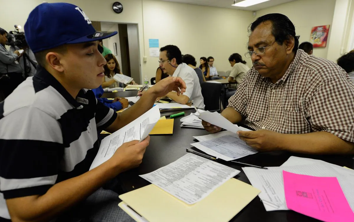A youth receives help from a volunteer with his application for Deferred Action for Childhood Arrivals program at Coalition for Humane Immigrant Rights in Los Angeles on Aug. 15, 2012. (Kevork Djansezian/Getty Images)
