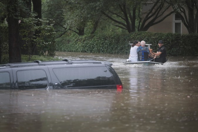 Volunteers and officers from the neiborhood security patrol help to rescue residents in the upscale River Oaks neighborhood after it was inundated with flooding from Hurricane Harvey on August 27, 2017 in Houston, Texas. (Scott Olson/Getty Images)