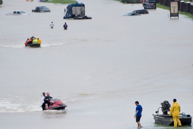 Volunteer rescuers evacuate people from a flooded residential area during the aftermath of Hurricane Harvey on August 29, 2017 in Houston, Texas. Floodwaters have breached a levee south of the city of Houston, officials said Tuesday, urging residents to leave the area immediately. (BRENDAN SMIALOWSKI/AFP/Getty Images)