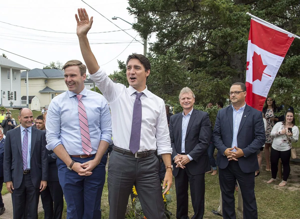Prime Minister Justin Trudeau, accompanied by New Brunswick Premier Brian Gallant, waves to the crowd as he arrives for a visit to Wee College daycare and early learning centre in Moncton, N.B. on Aug. 30, 2017. (The Canadian Press/Andrew Vaughan)
