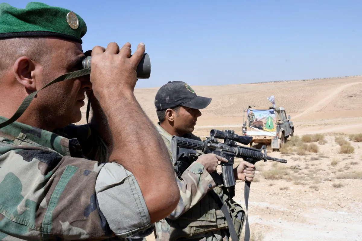 A Lebanese Army soldier looks through binoculars in Ras Baalbek, Lebanon August 28, 2017. (Reuters/ Hassan Abdallah)