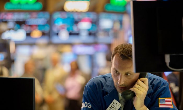 A trader works on the floor of the New York Stock Exchange at the closing bell of the Dow Jones Industrial Average on June 8, 2017. (Bryan R. Smith/AFP/Getty Images)
