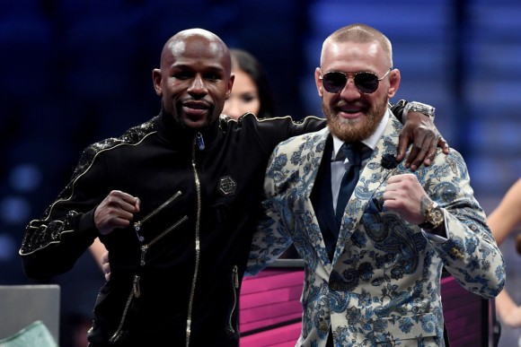 Floyd Mayweather Jr. (L) and Conor McGregor pose for pictures during a news conference after Mayweather's 10th-round TKO victory in their super welterweight boxing match on August 26, 2017 at T-Mobile Arena in Las Vegas, Nevada. (Photo by Ethan Miller/Getty Images)