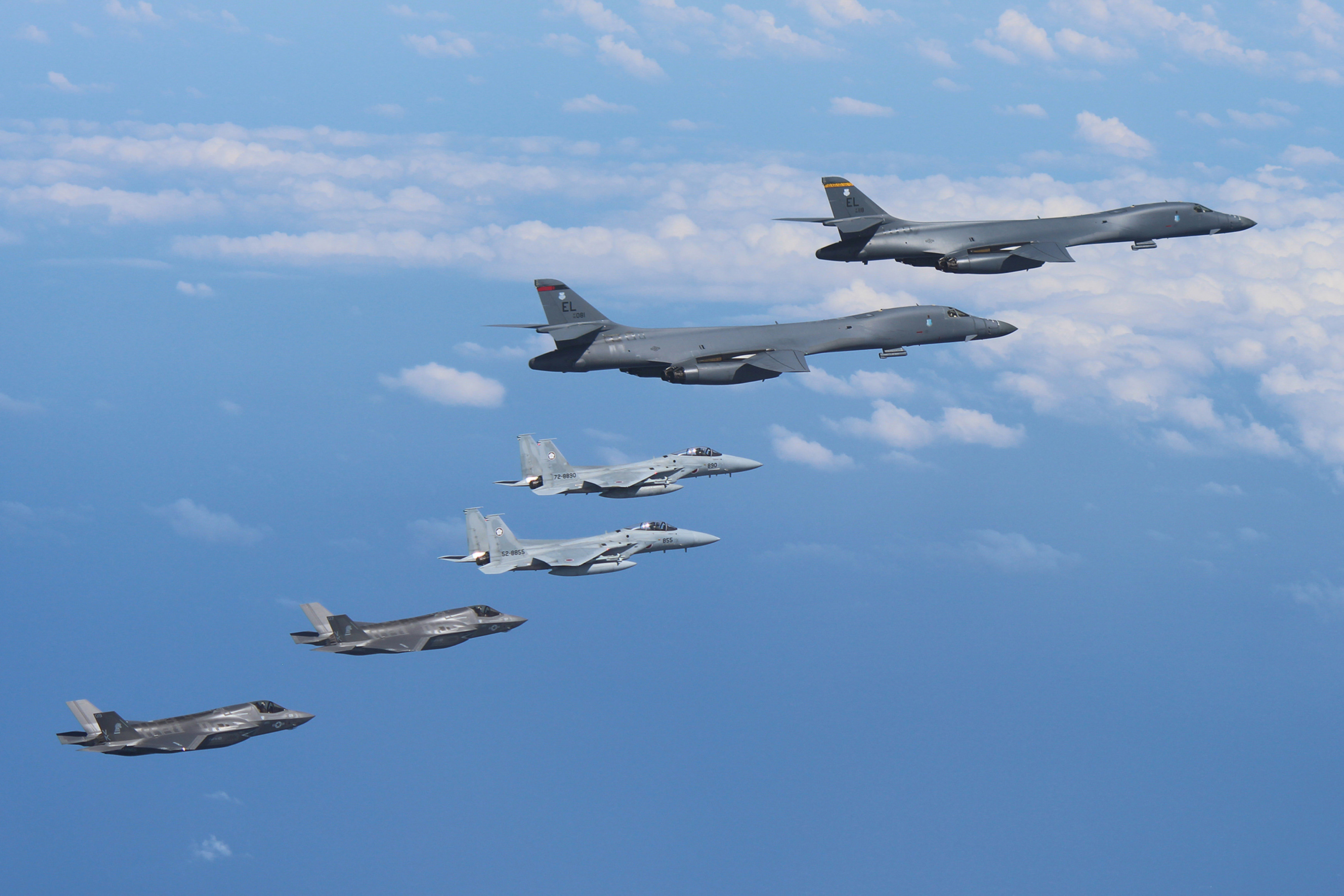 Two U.S. Air Force B-1B Lancer bombers fly from Andersen Air Force Base, Guam, for a mission, with an escort of a pair of Japan Self-Defense Forces F-15 fighter jets and U.S. Marines' F-35B fighter jets in the vicinity of Kyushu, Japan, in this photo released by Air Staff Office of the Defense Ministry of Japan August 31, 2017. Air Staff Office of the Defense Ministry of Japan/HANDOUT via REUTERS ATTENTION EDITORS - THIS IMAGE WAS PROVIDED BY A THIRD PARTY.
