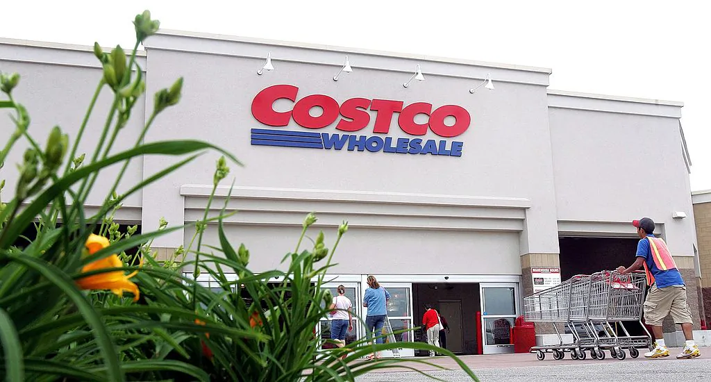  A worker pushes carts outside a Costco Wholesale store  in Mount Prospect, Illinois, on May 31, 2006. (Tim Boyle/Getty Images)