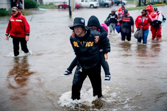 People walk to a Harris County Sheriff air boat while escaping a flooded neighborhood during the aftermath of Hurricane Harvey on August 29, 2017 in Houston, Texas. Hurricane Harvey has set what forecasters believe is a new rainfall record for the continental United States, officials said Tuesday. (BRENDAN SMIALOWSKI/AFP/Getty Images)