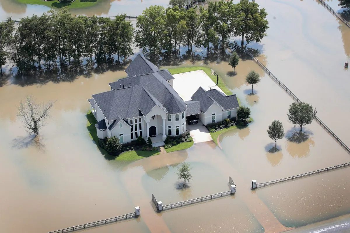 A mansion surrounded by floodwater after torrential rains pounded Southeast Texas is seen on August 31, 2017 near Sugar Land, Texas. While tempting for looters, law enforcement agencies are pledging increased penalties and determined prosecutions for crimes like looting and burglary committed in the wake of Hurricane Harvey. (Scott Olson/Getty Images)