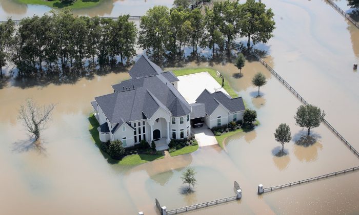 A mansion surrounded by floodwater after torrential rains pounded Southeast Texas is seen on August 31, 2017 near Sugar Land, Texas. While tempting for looters, law enforcement agencies are pledging increased penalties and determined prosecutions for crimes like looting and burglary committed in the wake of Hurricane Harvey. (Scott Olson/Getty Images)