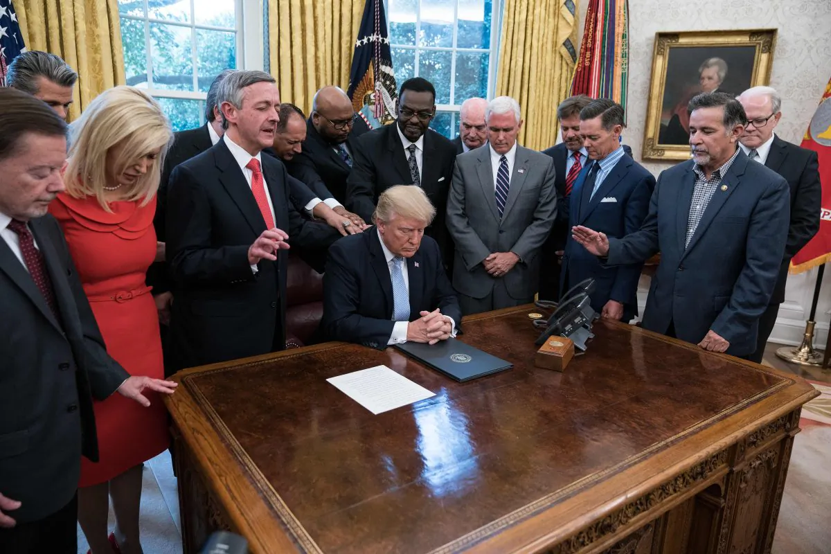 President Donald Trump and faith leaders pray in the Oval Office on Sept. 1, 2017, at the White House after Trump signed a proclamation calling for a national day of prayer on Sept. 3. (NICHOLAS KAMM/AFP/Getty Images)
