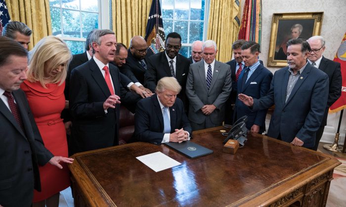 President Donald Trump and faith leaders pray in the Oval Office on Sept. 1, 2017, at the White House after Trump signed a proclamation calling for a national day of prayer on Sept. 3. (NICHOLAS KAMM/AFP/Getty Images)