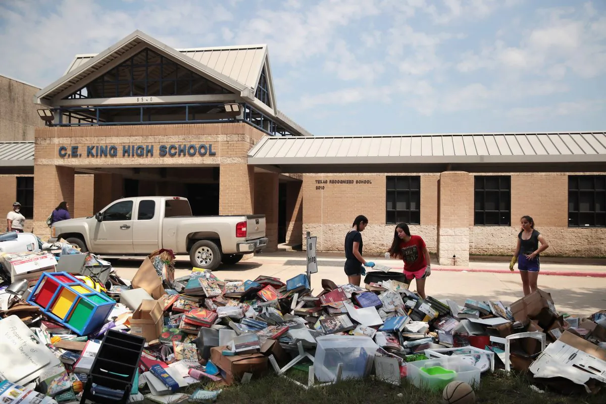Volunteers and students from C.E. King High School help to clean up the school after torrential rains caused widespread flooding in the area during Hurricane and Tropical Storm Harvey on September 1, 2017 in Houston, Texas. (Scott Olson/Getty Images)
