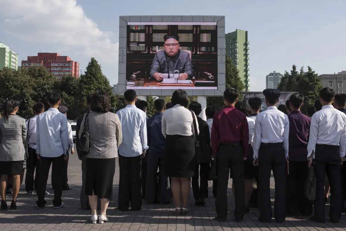 North Koreans watch a statement delivered by dictator Kim Jong Un on a television screen outside of the railway station in Pyongyang on Sept. 22. (Ed Jones/AFP/Getty Images)