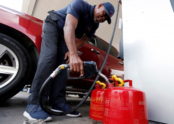 Cains Lawrence fills gasoline cans at the Fuel City service station in the aftermath of Hurricane Harvey, in Dallas, Texas, U.S., September 1, 2017. (REUTERS/Brandon Wade)